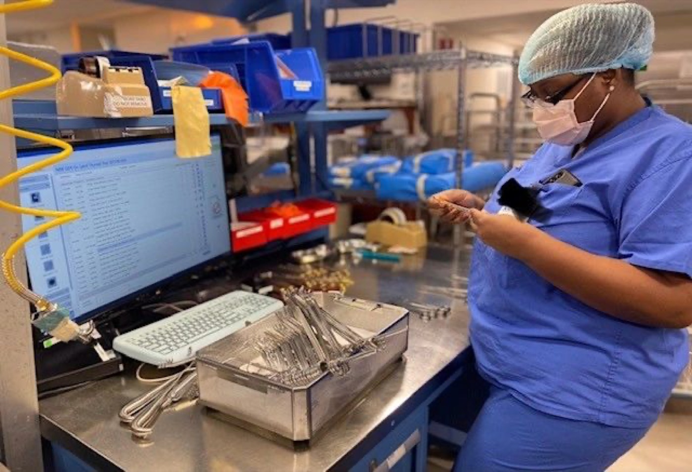 A sterile processing student assembling an instrument tray